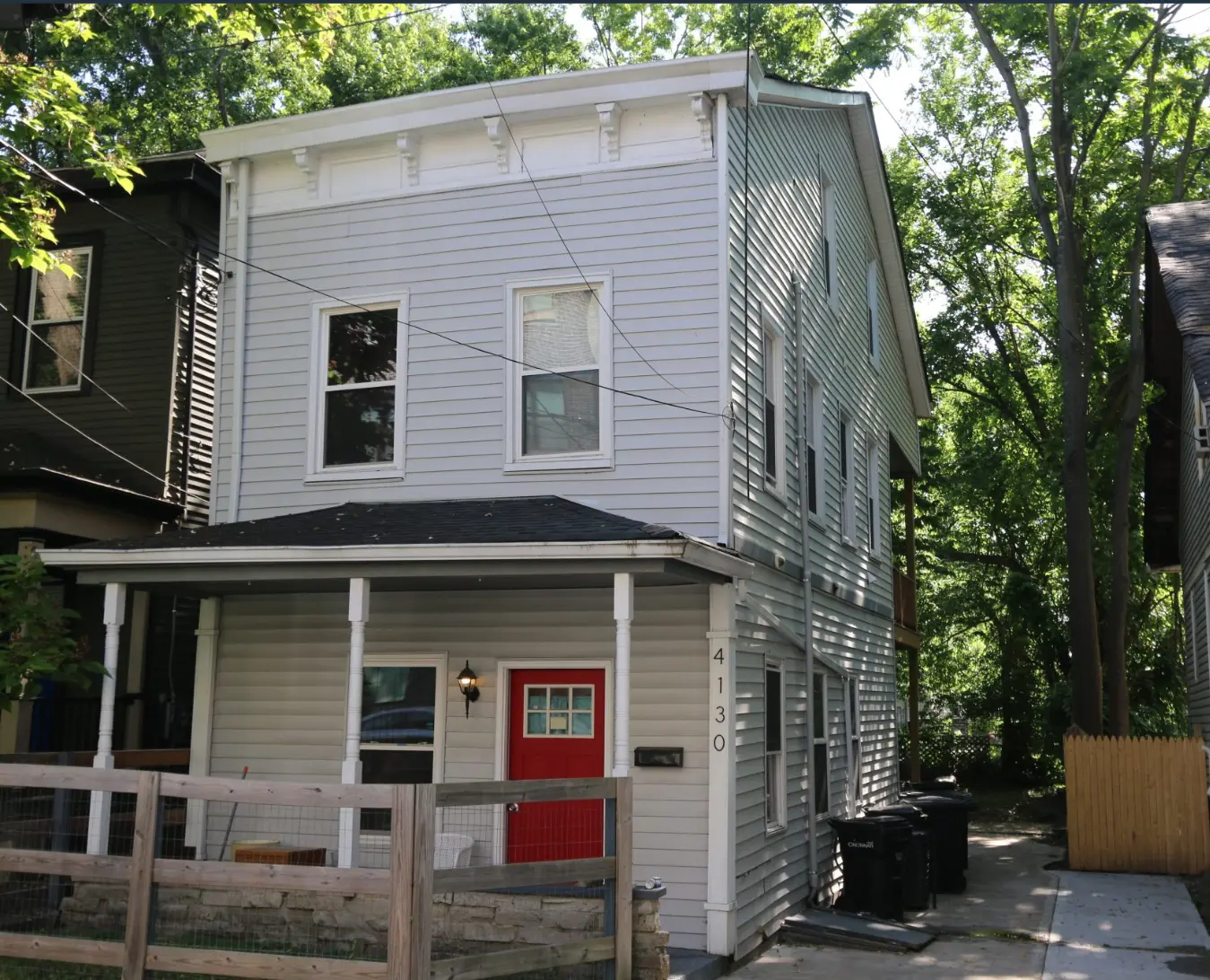 Light gray two-story Dream Chasers home with a red front door.