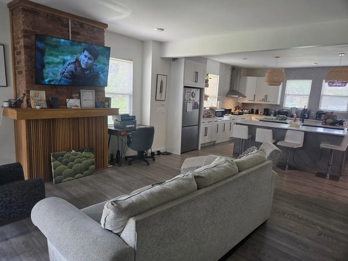 Open living room and kitchen in one of our homes, with a breakfast bar.